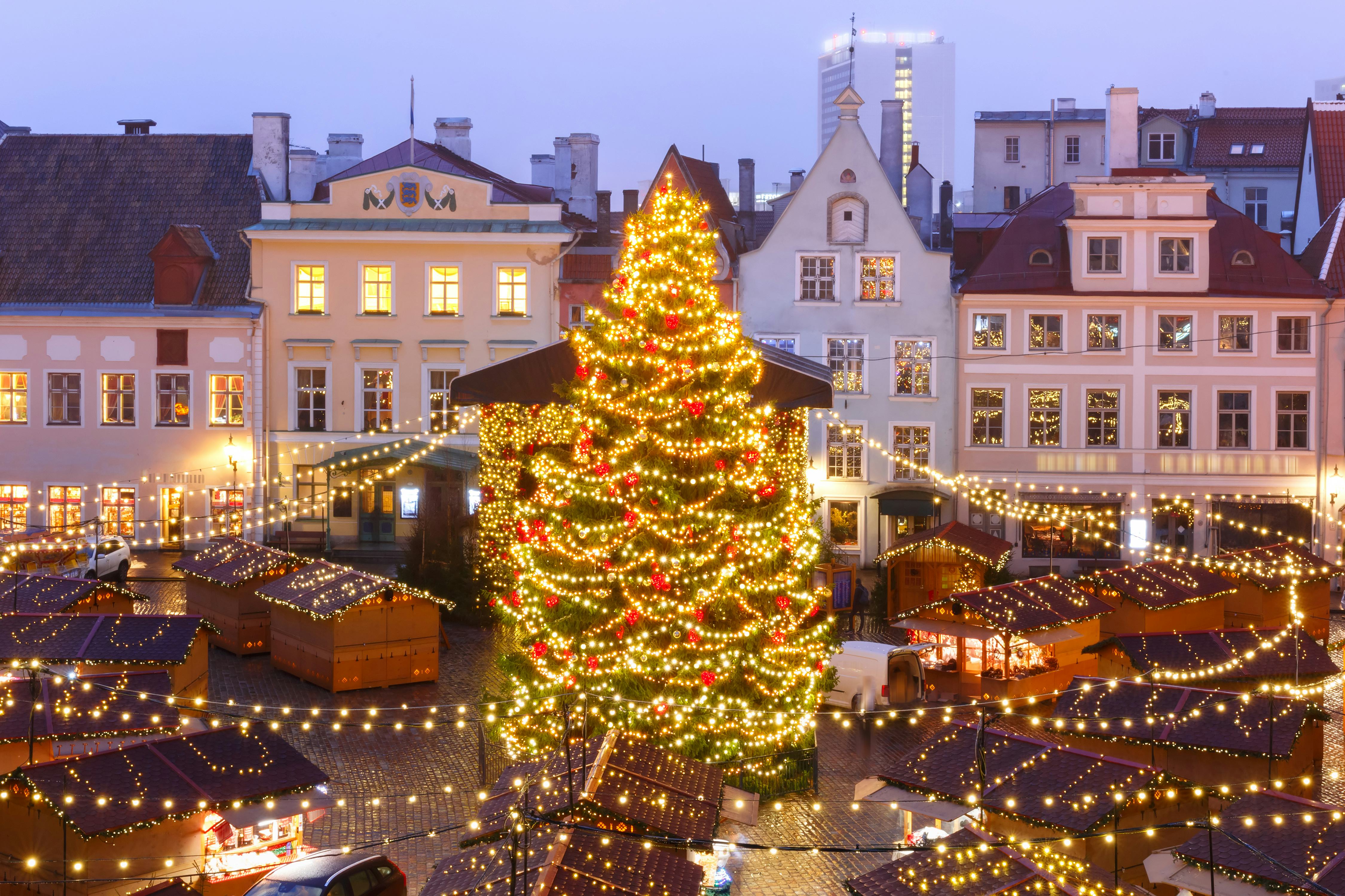 Decorated and illuminated Christmas tree and Christmas Market at Town Hall Square or Raekoja plats, Tallinn, Estonia. Aerial view