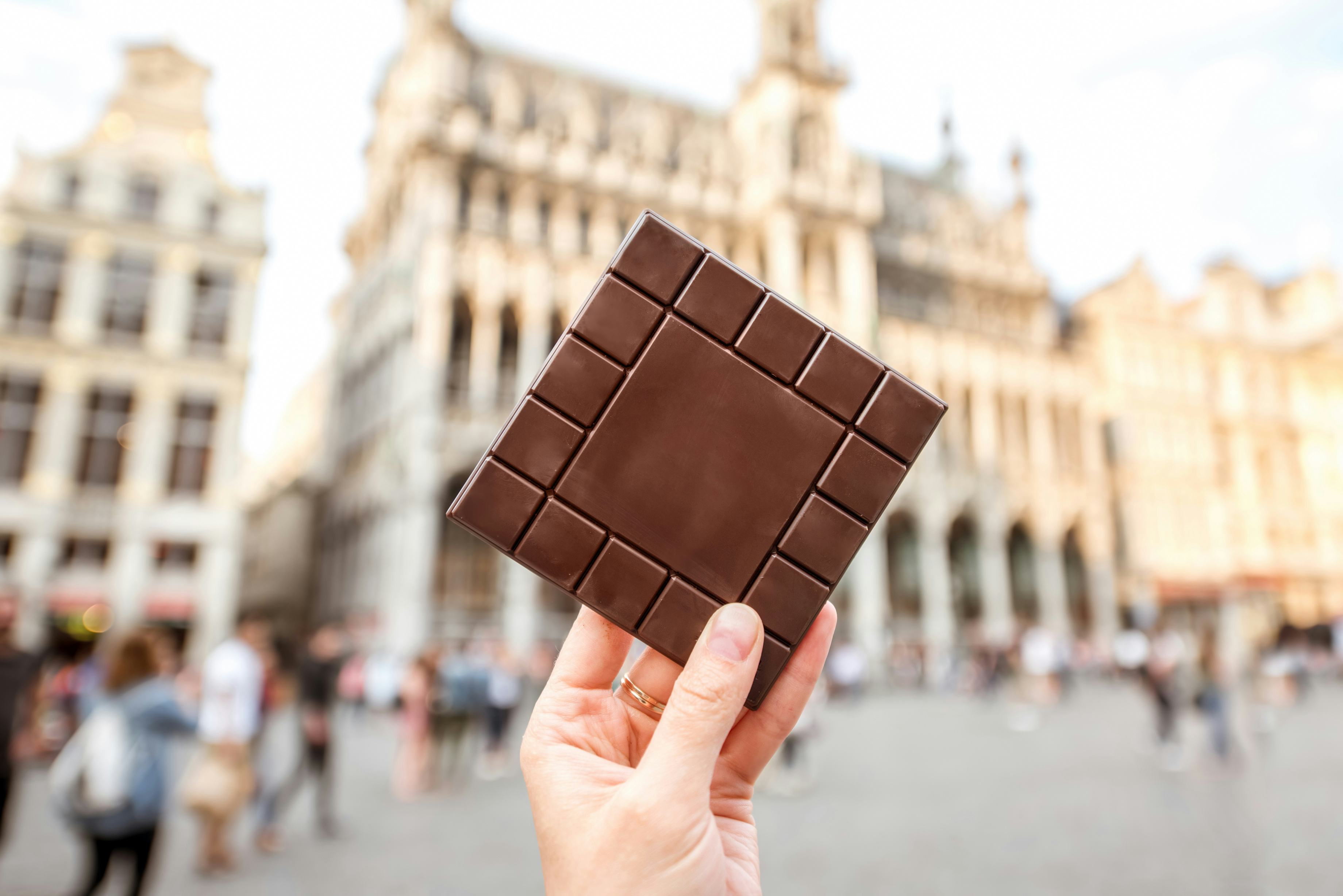 Milk chocolate square being held up in Brussels, Belgium