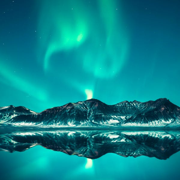Northern lights with mountains, ice and a lake