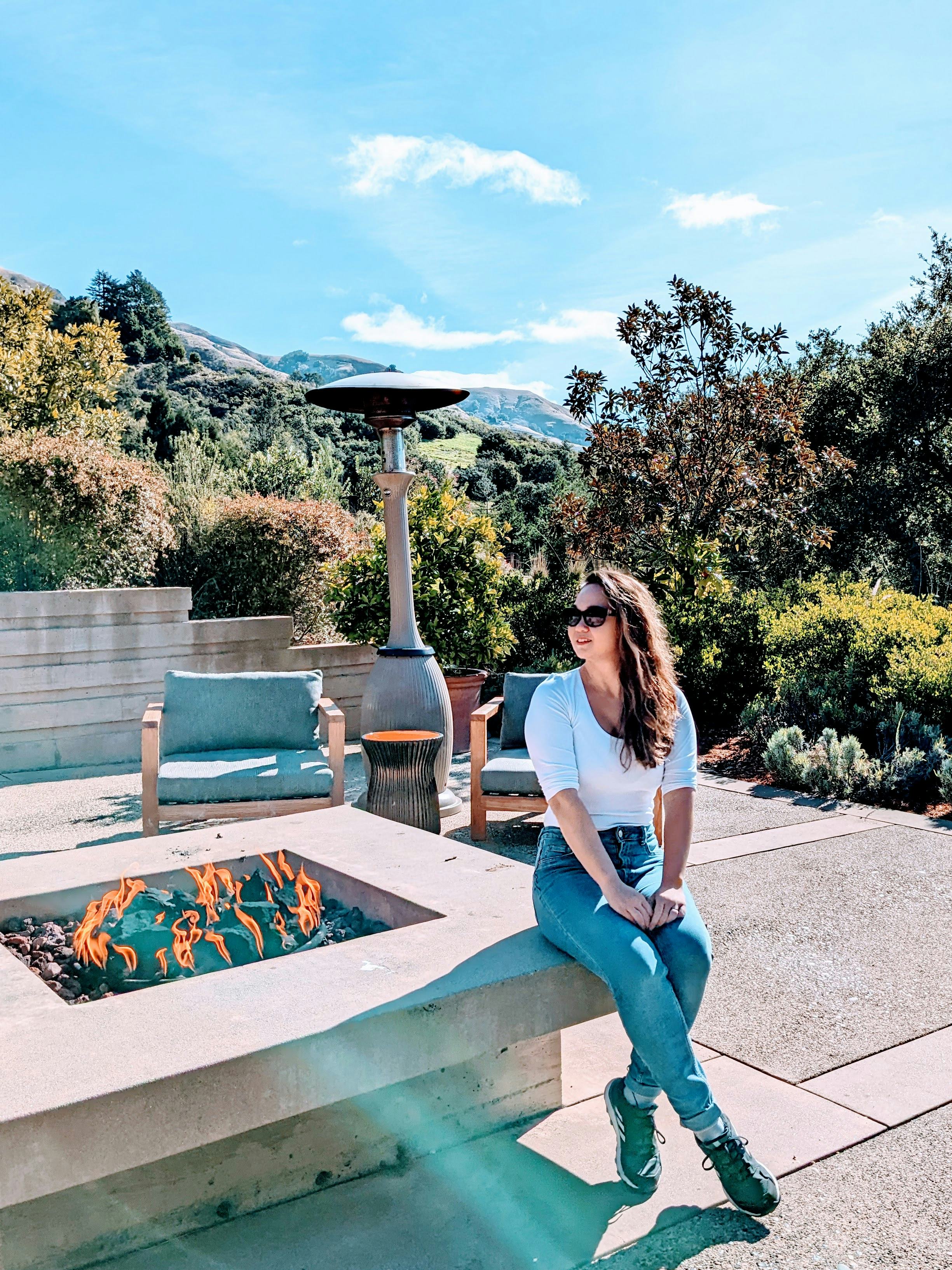 Julia Menez sitting by a fair place while on a trip abroad