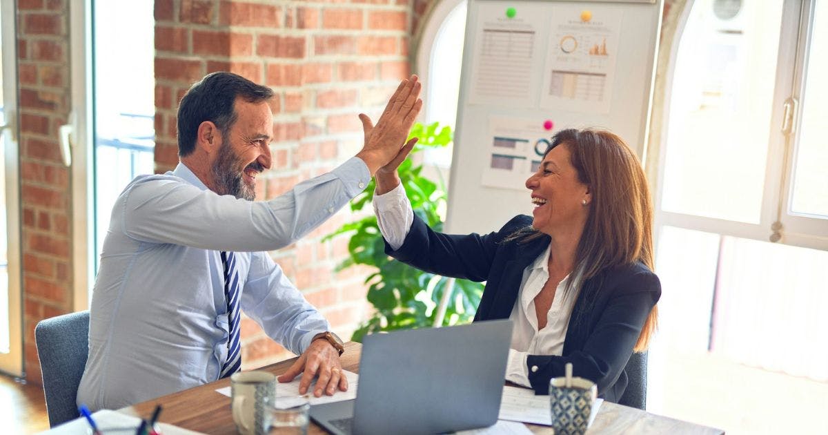 A man and woman high fiving