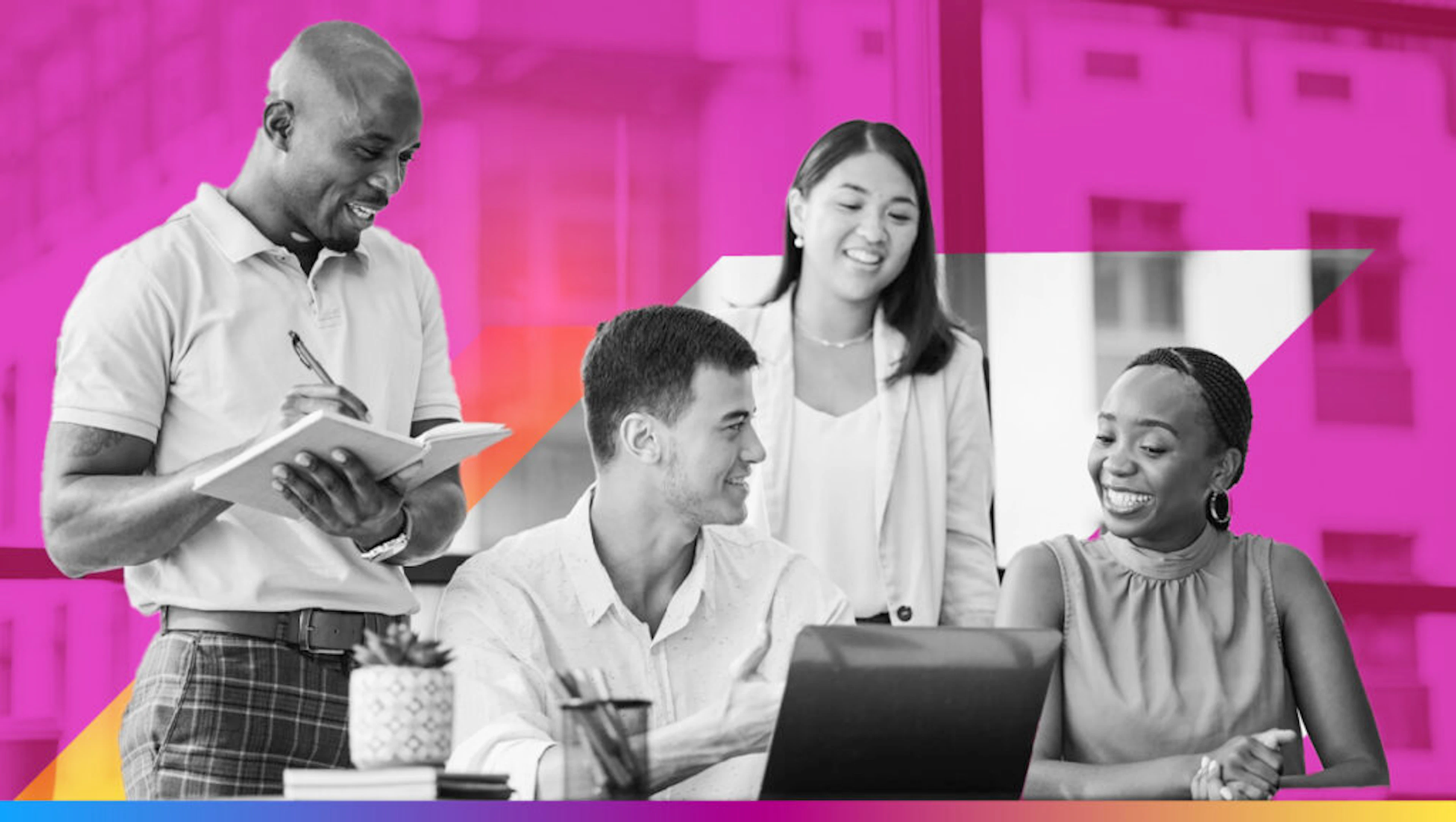 four people around a computer smiling