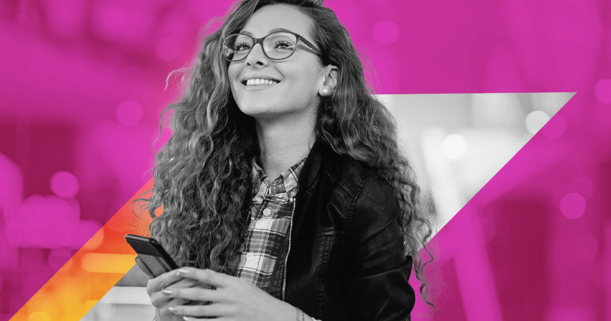 Person with pink background looking off into the distance smiling
