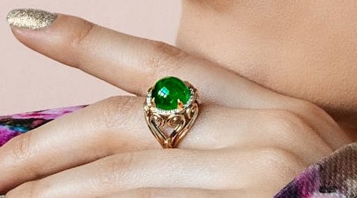 A large ring with an emerald.