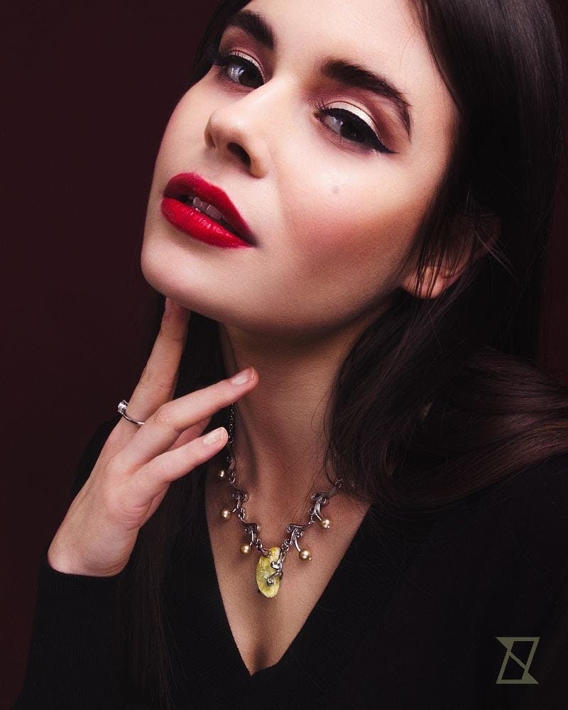 Baltic amber necklace on a neck of a model.