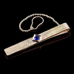 A tie clip with a sapphire.