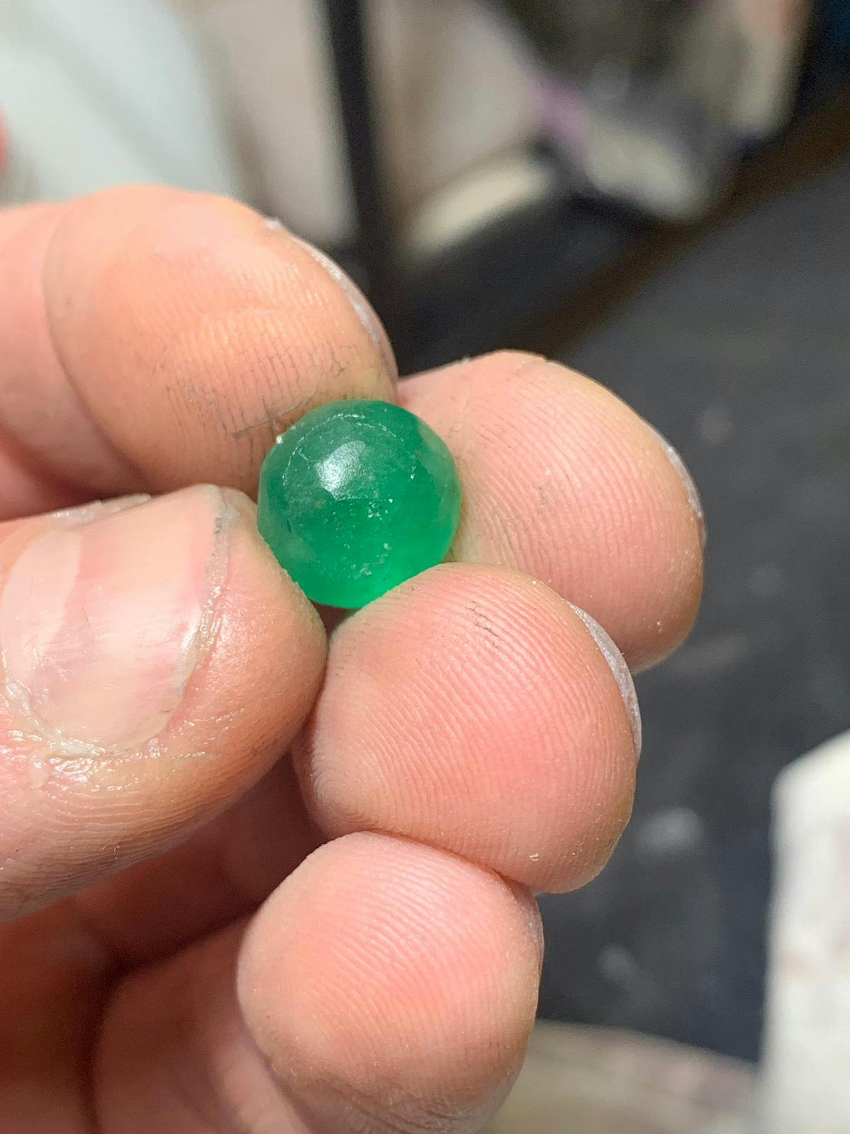 Sphere shaped emerald ready to polish.