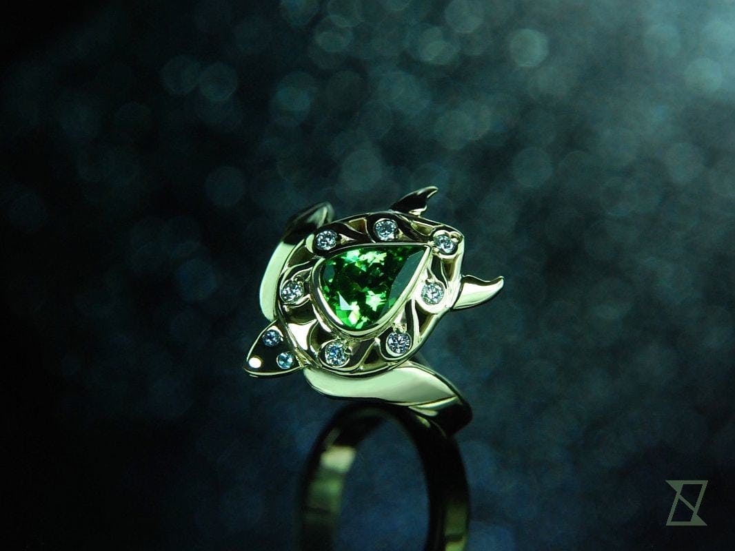 Turtle ring with tsavorite and diamonds in green gold.