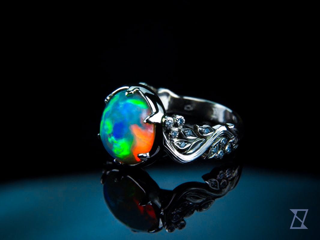 King of colours featuring 5.5 ct opal and diamonds set in white 14k gold.