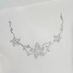 Necklace in the shape of plumeria flowers with diamonds.