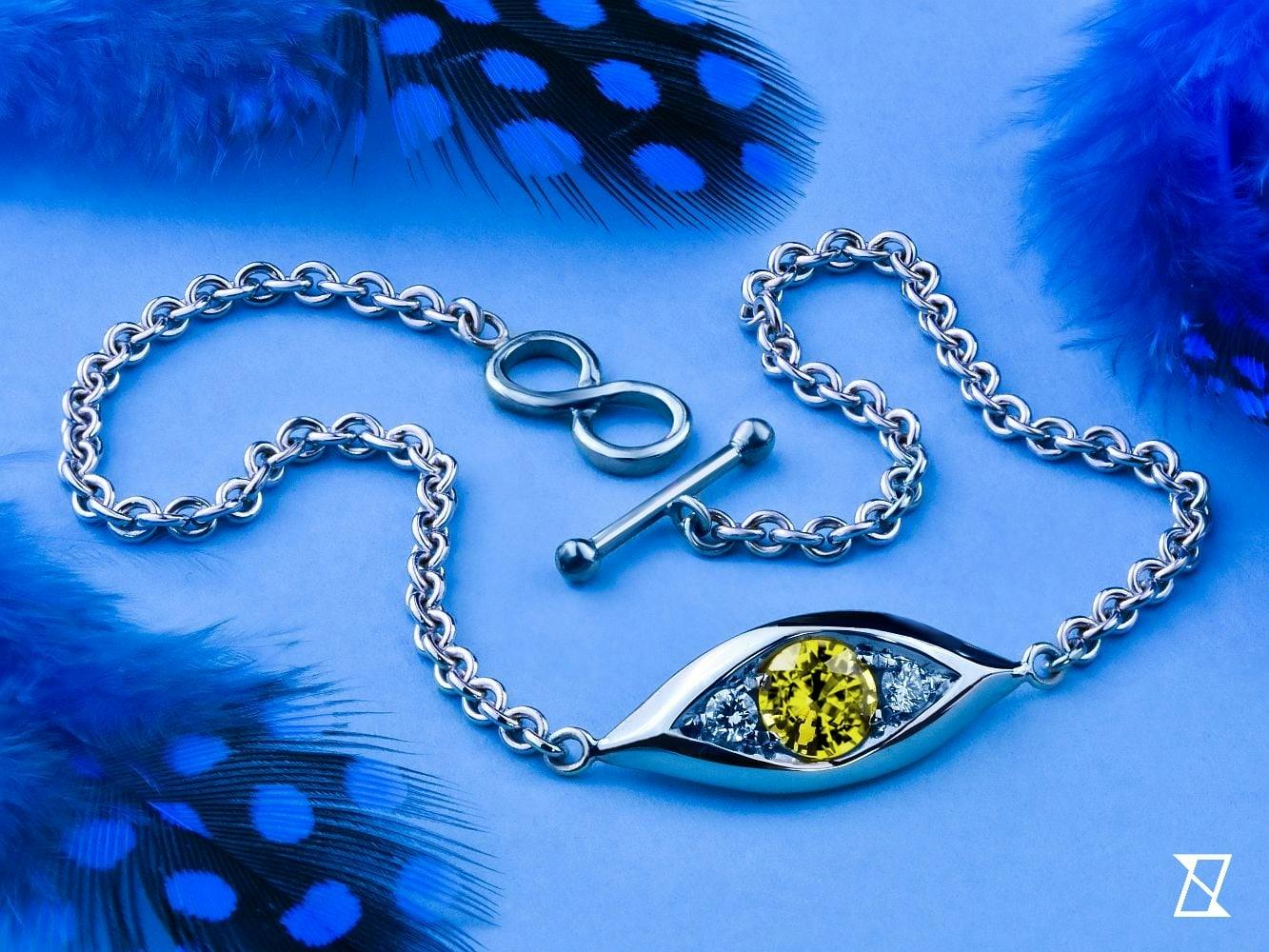 Pukhraj sapphire with diamonds in white gold eye bracelet.