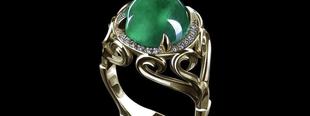 Ring with an emerald sphere with diamonds in yellow gold.