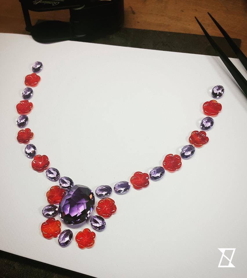 Perfect match layout of gemstones ready to be set in the floral pink palladium gold necklace. 