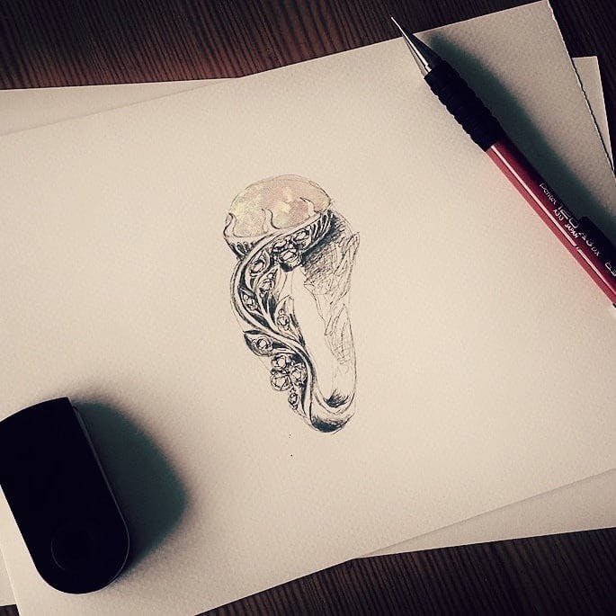 A design of a custom opal ring with diamonds. 