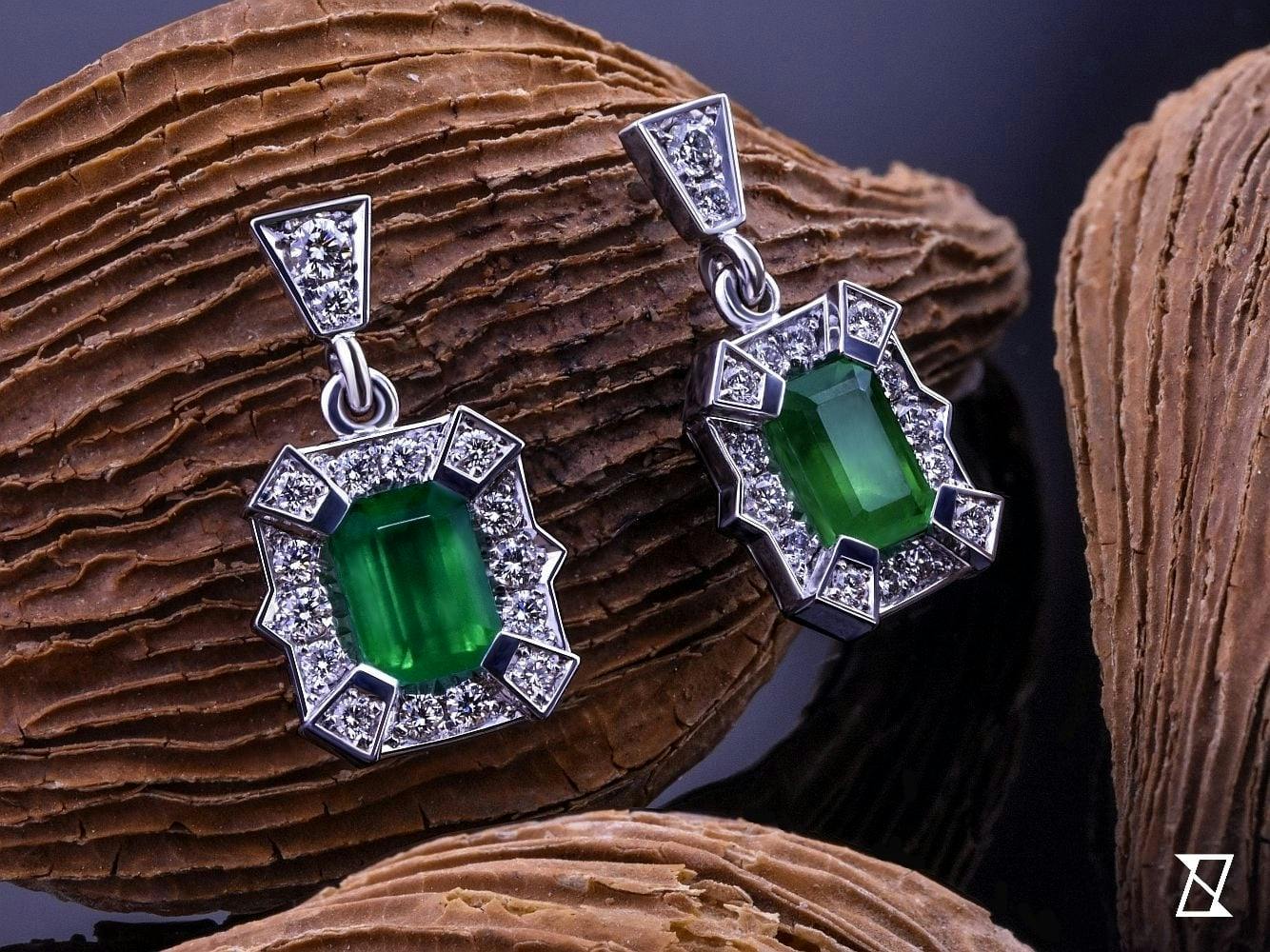 Earrings with colombian elemralds with diamonds in 14k white gold.