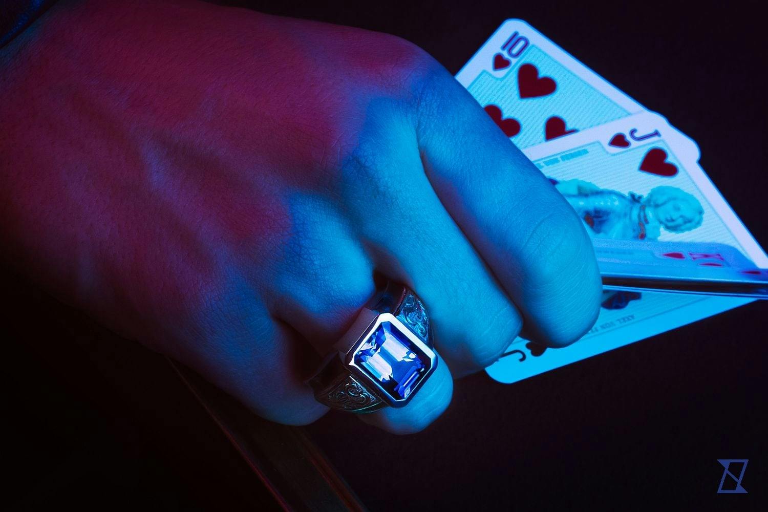 A man's ring on a hand of a bold player. 