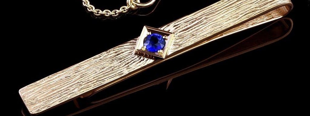 A tie clip with a sapphire.