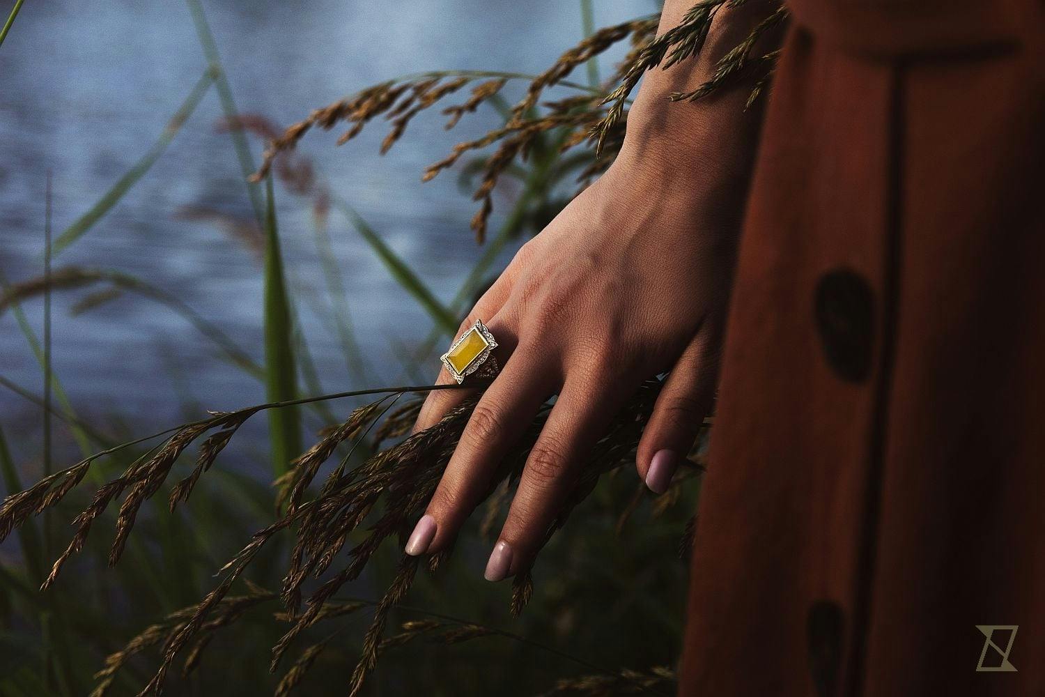 Amber ring on a hand. 