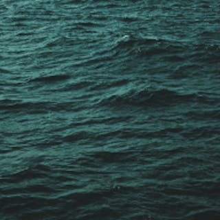 Square image of the ocean tinted teal
