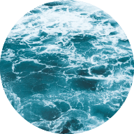 Circle image of the ocean with a teal tinted filter over the top