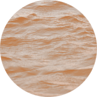 Circle image of the ocean with an orange coloured filter over the top
