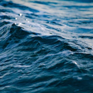 Square image of the ocean tinted teal