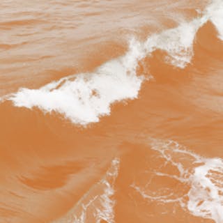 Square image of the ocean with an orange coloured filter over the top