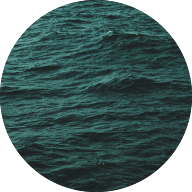 Circle image of the ocean with a teal tinted filter over the top