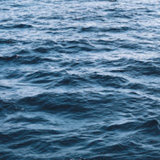 Square image of the ocean tinted teal