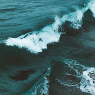 Square image of the ocean tinted teal
