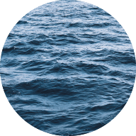 Circle image of the ocean with a teal tinted filter over the top