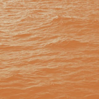 Square image of the ocean with an orange coloured filter over the top
