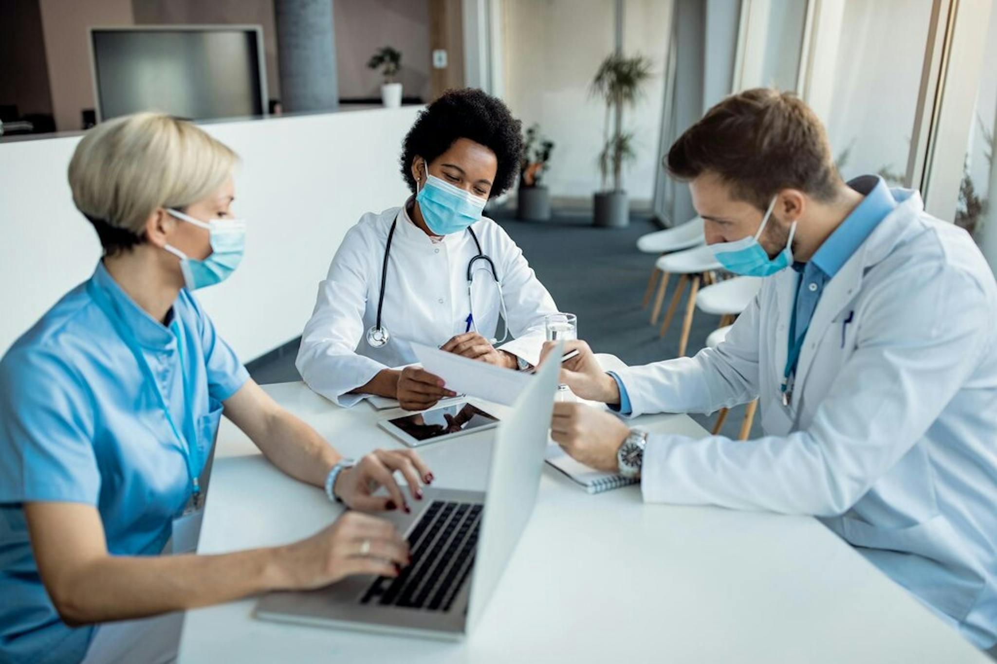 doctor-analyzing-medical-reports-with-her-colleagues