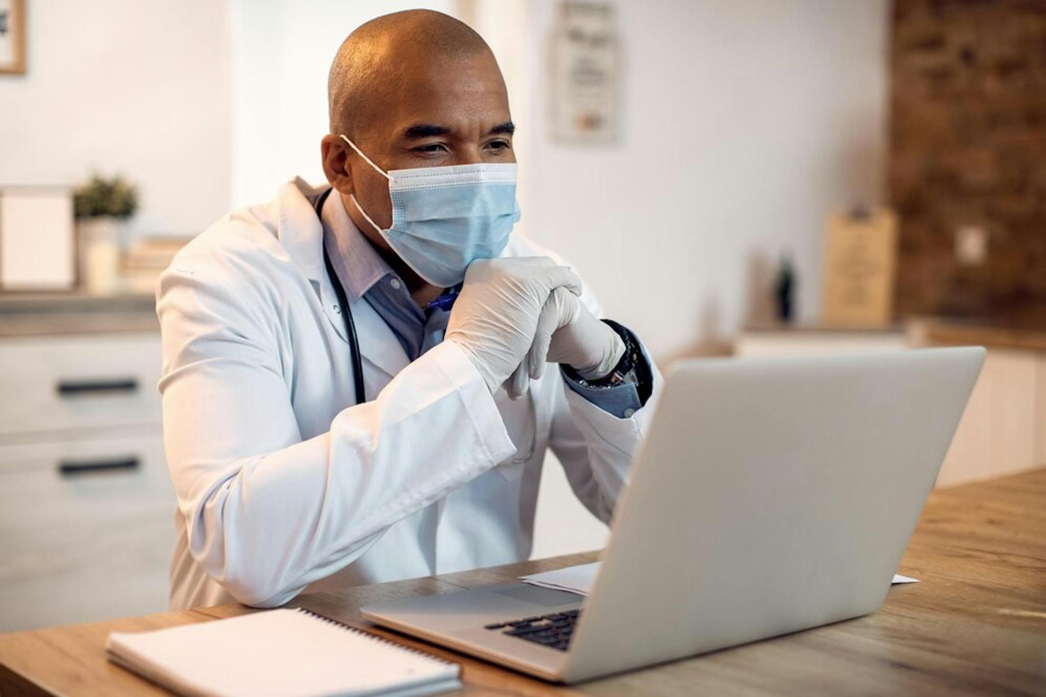 doctor-with-protective-face-mask-waiting-for-telehealth-appointment