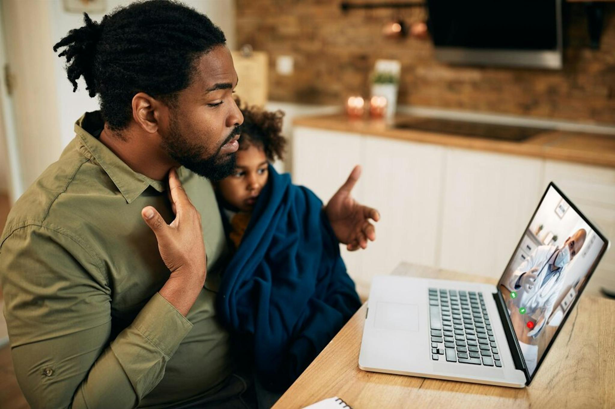 father-having-telehealth-appointment-with-family-doctor