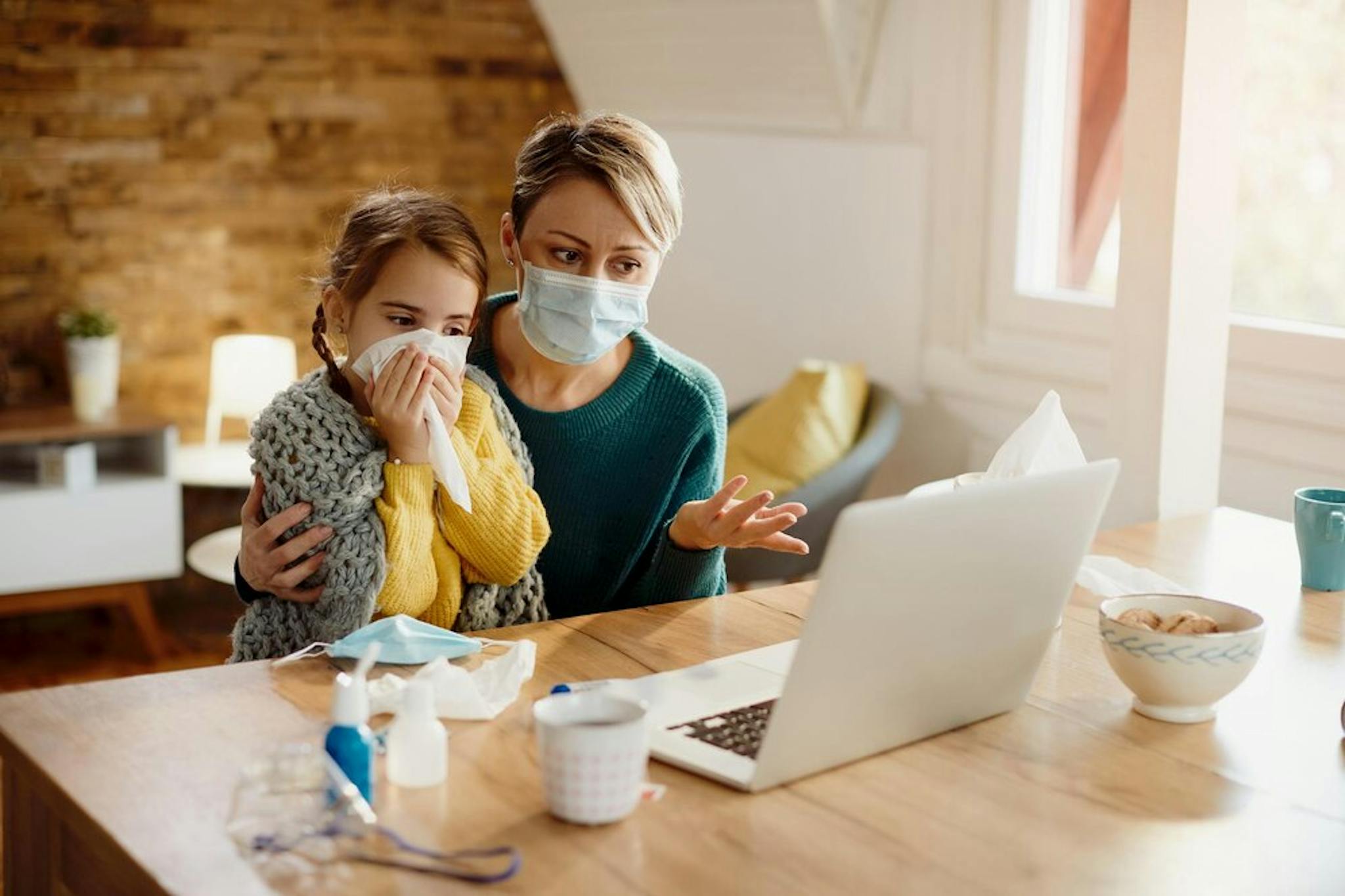 mother-with-her-ill-daughter-on-call-with-doctor-from-home