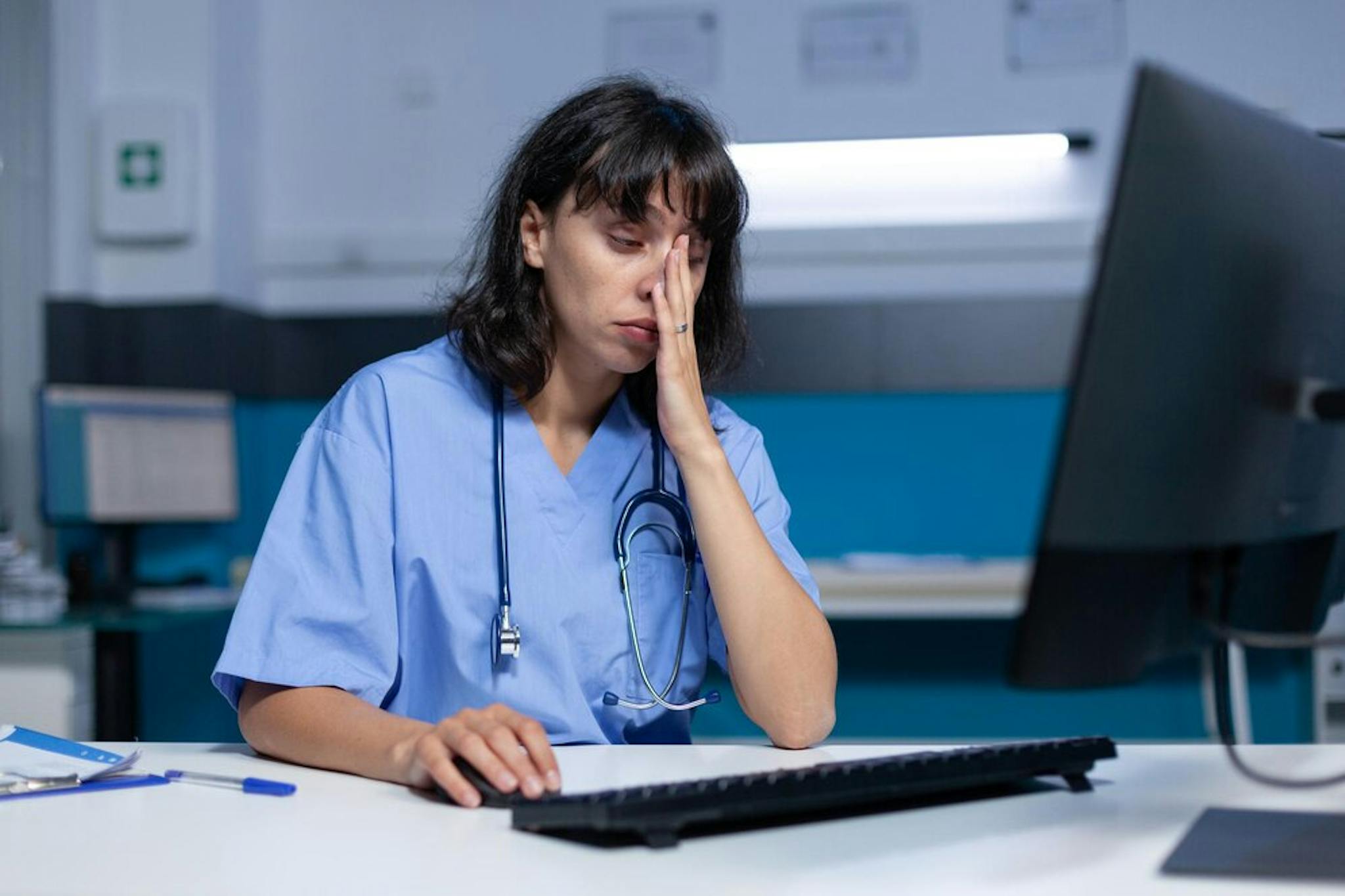 overworked-medical-assistant-falling-asleep-while-typing