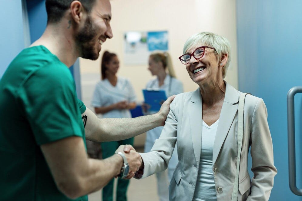 happy-surgeon-senior-woman-handshaking