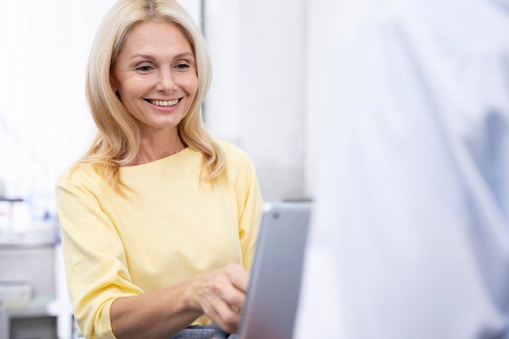 close-up-smiley-patient-with-tablet_23