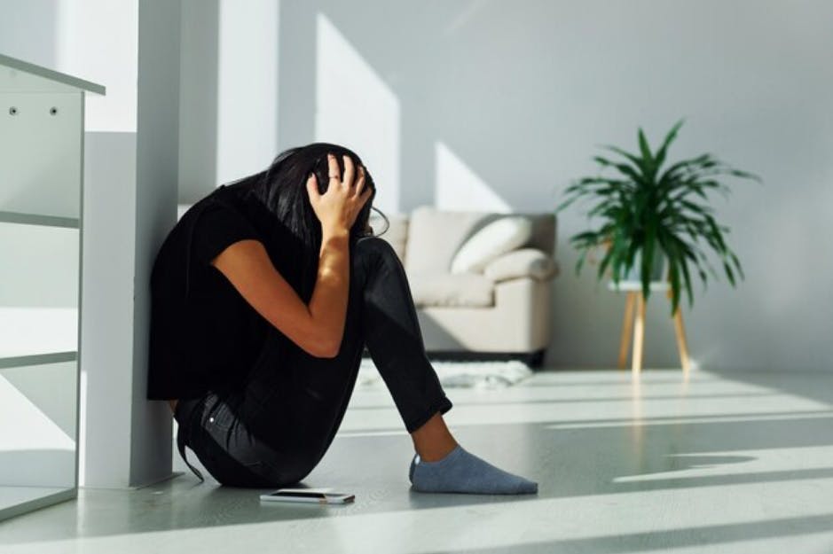 anxious-woman-sitting-on-floor