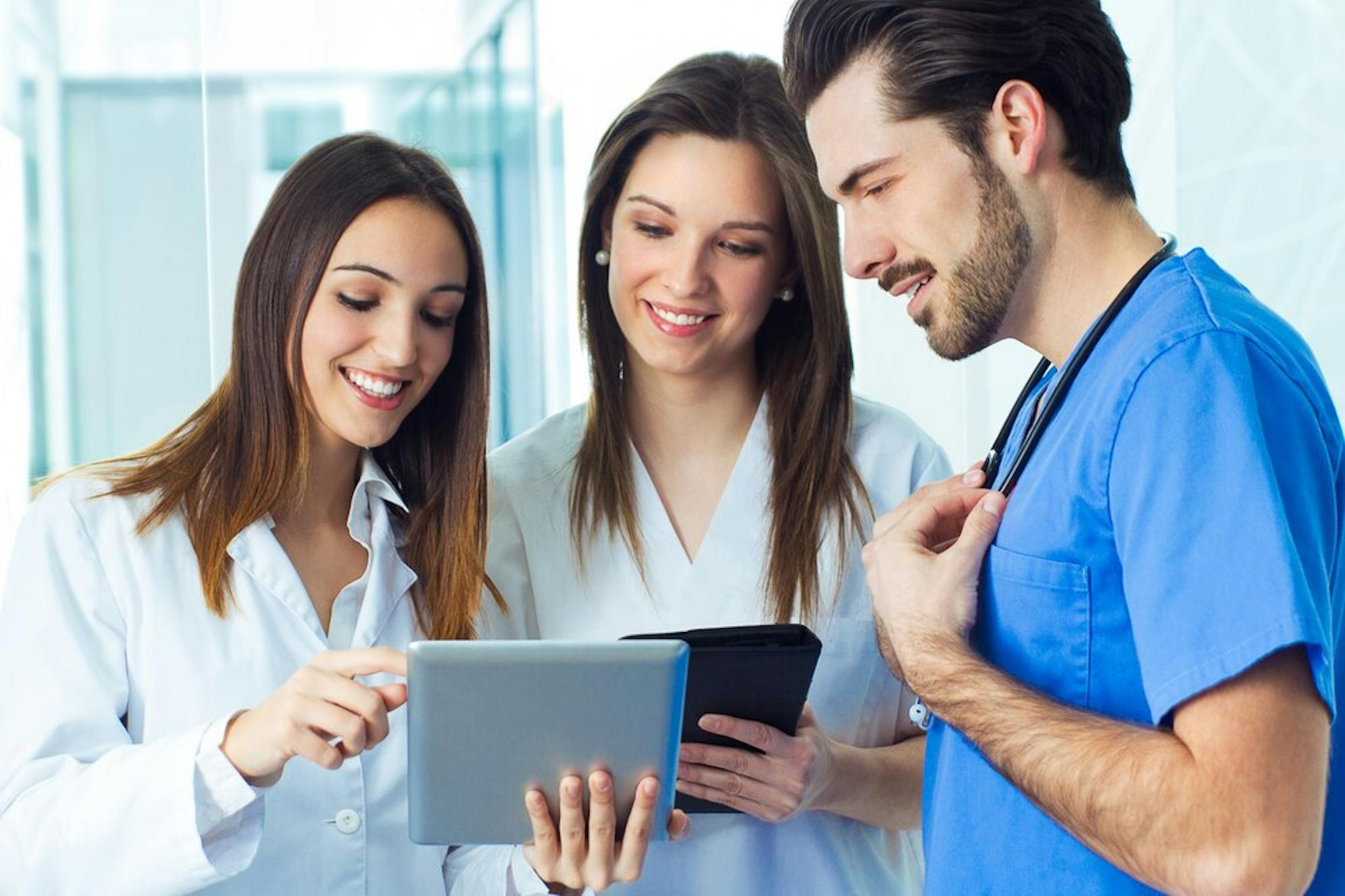 group-of-healthcare-workers-smiling-at-phone-screen