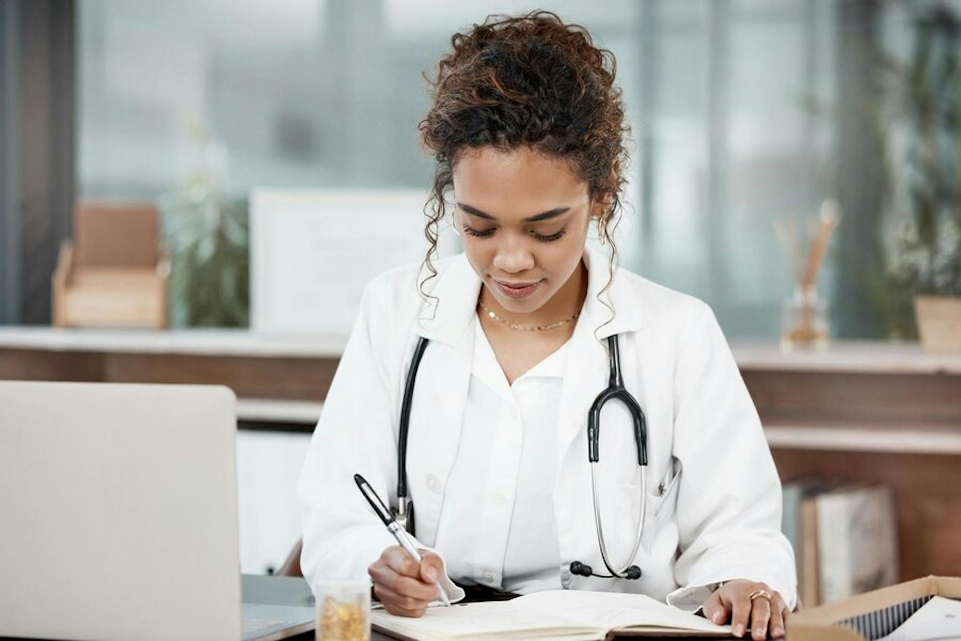 female-doctor-with-journal-and-laptop