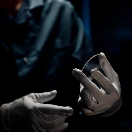 A doctor holds a lens